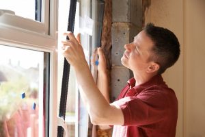 worker installing a new window
